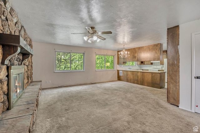 787 E 4800 S, Murray, UT 84107 - unfurnished living room with ceiling fan, a chandelier, a fireplace, and light carpet