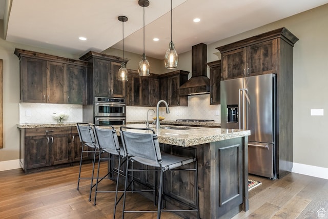 1773 E Longview Dr, Hideout, UT 84036 - kitchen with appliances with stainless steel finishes, custom exhaust hood, dark brown cabinetry, light stone counters, and recessed lighting