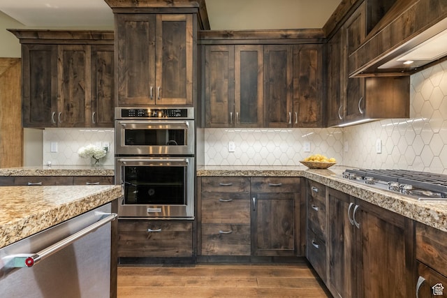 1773 E Longview Dr, Hideout, UT 84036 - kitchen featuring appliances with stainless steel finishes, wall chimney exhaust hood, and dark brown cabinets