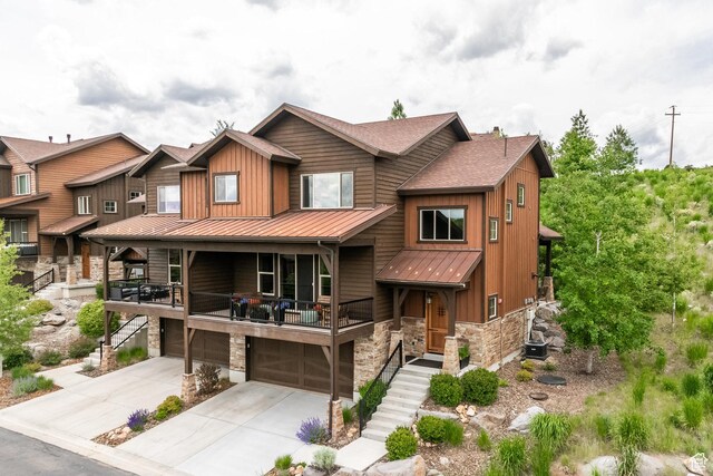 1773 E Longview Dr, Hideout, UT 84036 - view of front of home featuring a standing seam roof, stone siding, a garage, and driveway