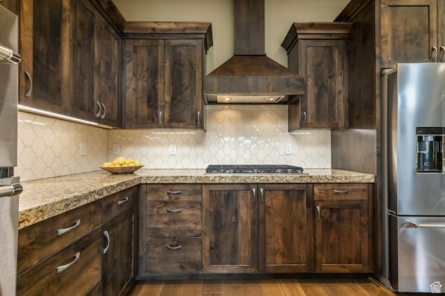 1773 E Longview Dr, Hideout, UT 84036 - kitchen with stainless steel appliances, wall chimney range hood, dark brown cabinets, and backsplash