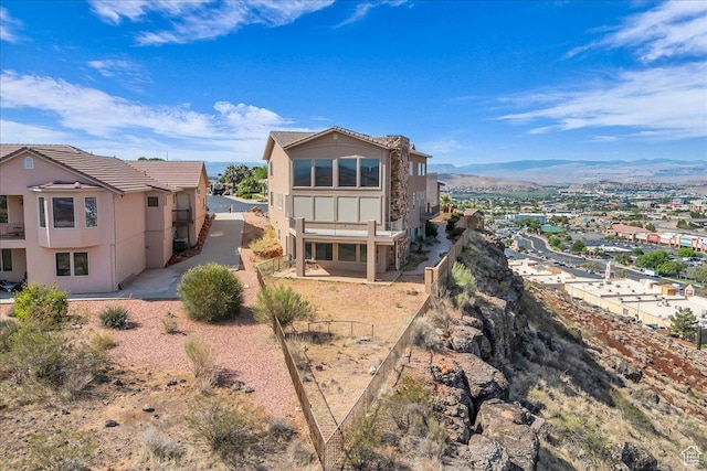 393 N Crestline Cir, St George, UT 84790 - back of house with stucco siding, a mountain view, and a tile roof