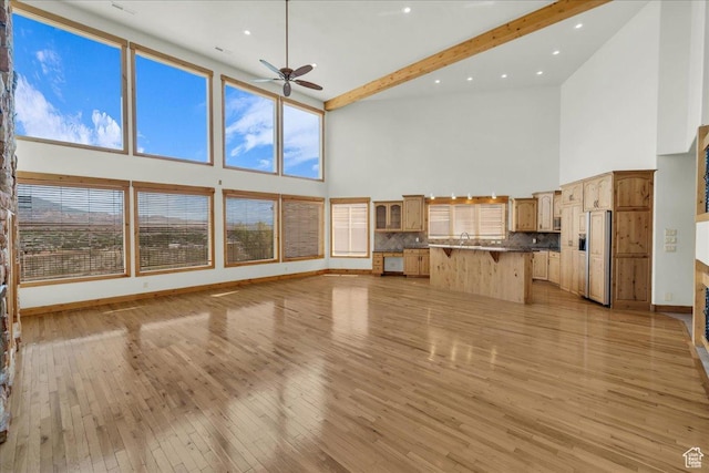 393 N Crestline Cir, St George, UT 84790 - unfurnished living room with high vaulted ceiling, ceiling fan, light wood-style floors, beamed ceiling, and recessed lighting