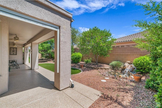 1621 W Wonderstone Dr, St George, UT 84790 - fenced backyard featuring a ceiling fan and a patio area