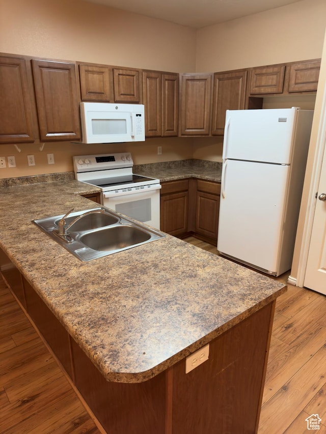 1513 W 190 N, Pleasant Grove, UT 84062 - kitchen featuring white appliances, a peninsula, light wood-type flooring, and brown cabinets