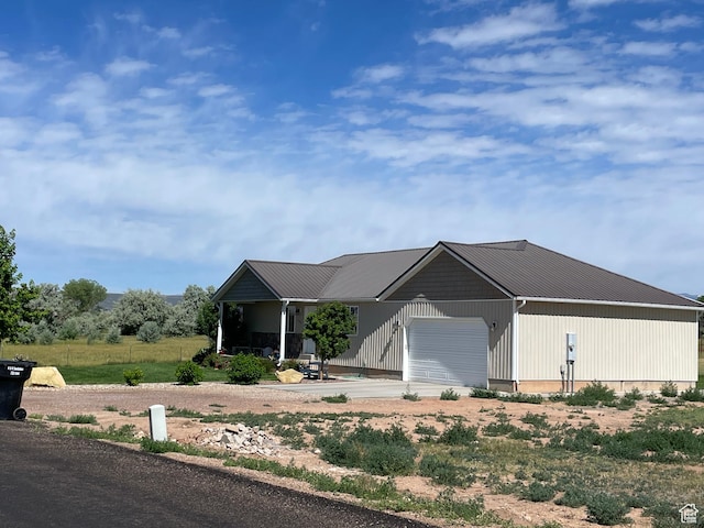 2156 W 4750 N, Roosevelt, UT 84066 - view of front of home featuring an attached garage, a metal roof, and concrete driveway