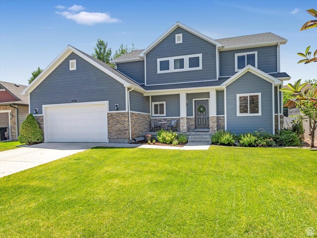 430 E 2010 S, Heber City, UT 84032 - craftsman-style home with an attached garage, a front yard, driveway, a shingled roof, and stone siding