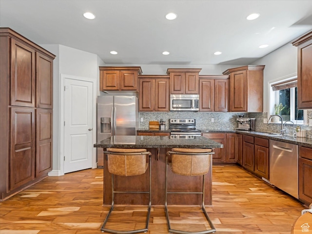 430 E 2010 S, Heber City, UT 84032 - kitchen with appliances with stainless steel finishes, a kitchen island, light wood-type flooring, decorative backsplash, and recessed lighting