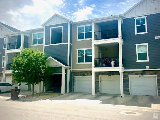 55 W Silver Springs Dr Unit F, Vineyard, UT 84059 - view of building exterior with a garage