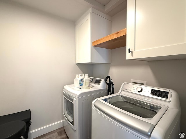 3052 N Mountain Rd, North Ogden, UT 84414 - washroom with cabinet space, washing machine and clothes dryer, and wood finished floors