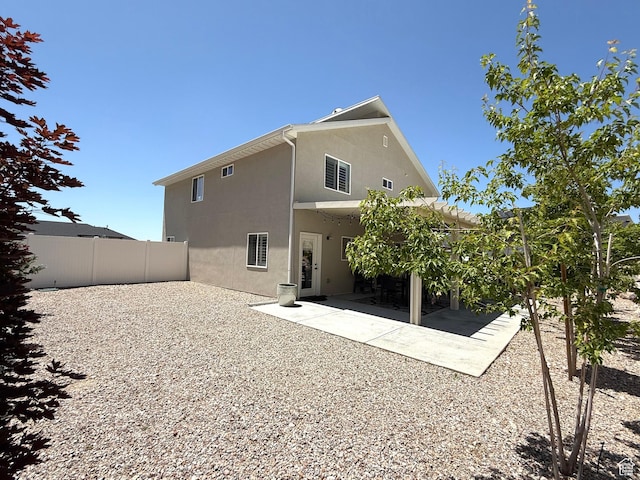 3052 N Mountain Rd, North Ogden, UT 84414 - rear view of property with stucco siding, a fenced backyard, and a patio area