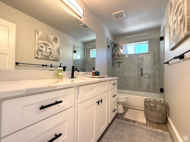 3052 N Mountain Rd, North Ogden, UT 84414 - full bathroom with vanity, shower / bath combination with glass door, a textured ceiling, and wood finished floors