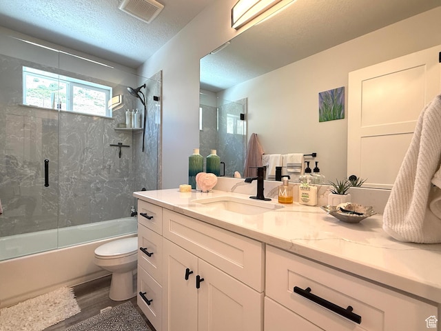 3052 N Mountain Rd, North Ogden, UT 84414 - bathroom with vanity, combined bath / shower with glass door, wood finished floors, and a textured ceiling