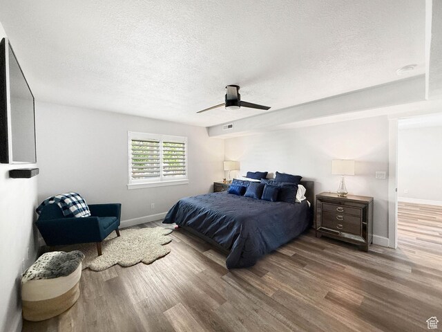 3052 N Mountain Rd, North Ogden, UT 84414 - bedroom featuring wood finished floors, a textured ceiling, and a ceiling fan