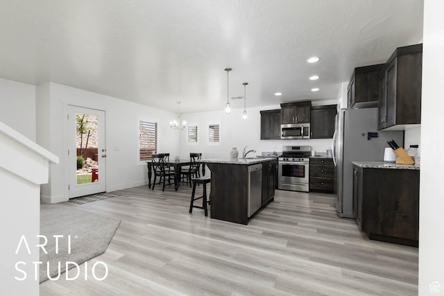 6297 S Zelda Dr, St George, UT 84790 - kitchen featuring stainless steel appliances, a breakfast bar area, a chandelier, recessed lighting, and a kitchen island with sink