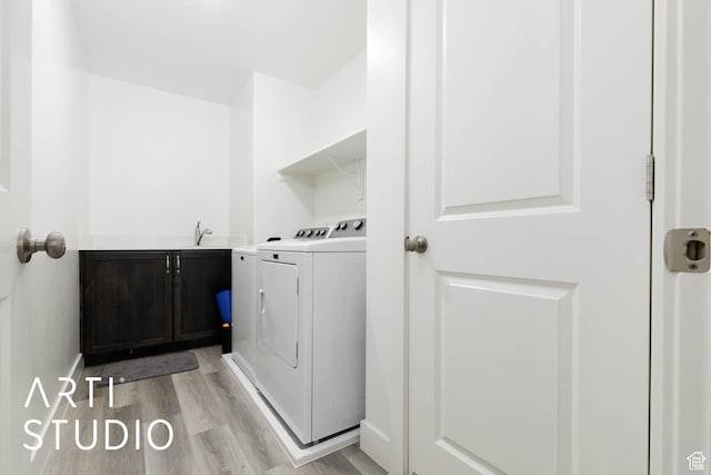 6297 S Zelda Dr, St George, UT 84790 - laundry room featuring washing machine and clothes dryer, light wood-style flooring, and cabinet space