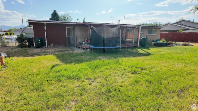 2617 S Ridgeland W, West Valley City, UT 84119 - back of house featuring a trampoline