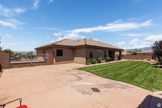 1883 S Purple Sage Dr, Washington, UT 84780 - rear view of house with stucco siding, a mountain view, a patio area, and a tile roof