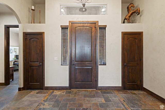 1883 S Purple Sage Dr, Washington, UT 84780 - foyer entrance with stone tile flooring and arched walkways