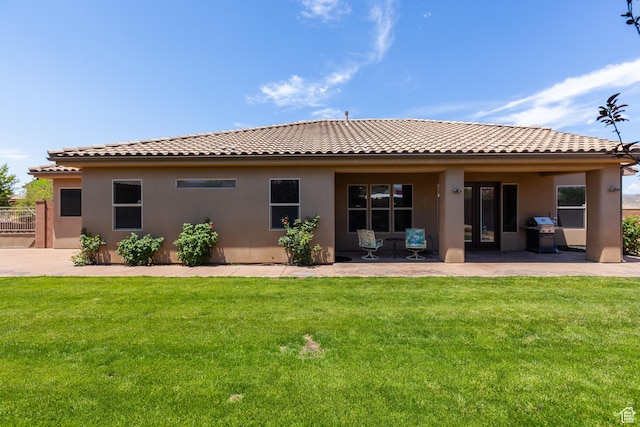 1883 S Purple Sage Dr, Washington, UT 84780 - back of house with a tile roof, stucco siding, a lawn, and a patio