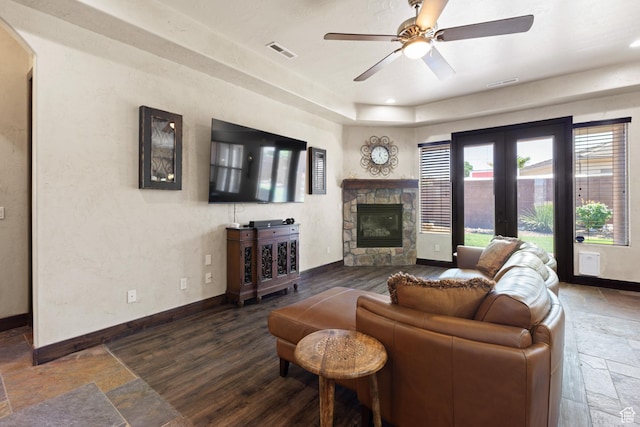 1883 S Purple Sage Dr, Washington, UT 84780 - living room featuring stone tile flooring, a fireplace, a ceiling fan, arched walkways, and recessed lighting