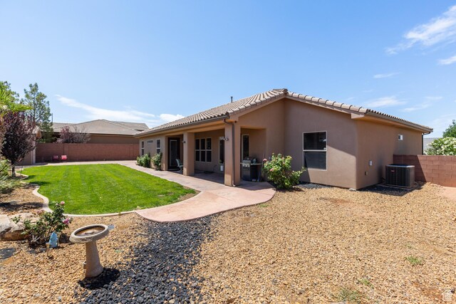 1883 S Purple Sage Dr, Washington, UT 84780 - back of house featuring a fenced backyard, stucco siding, a tile roof, and a patio area