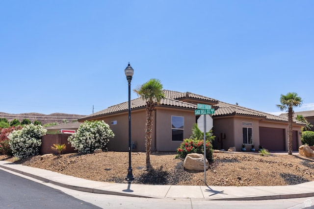 1883 S Purple Sage Dr, Washington, UT 84780 - view of front of property featuring a garage, stucco siding, and a tiled roof