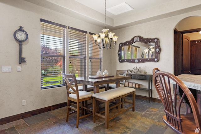 1883 S Purple Sage Dr, Washington, UT 84780 - dining space with stone tile flooring, arched walkways, and a chandelier