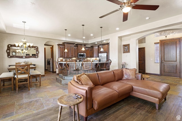 1883 S Purple Sage Dr, Washington, UT 84780 - living area with arched walkways, stone tile flooring, a chandelier, a ceiling fan, and recessed lighting