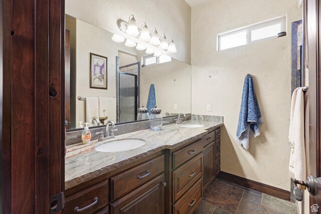 1883 S Purple Sage Dr, Washington, UT 84780 - bathroom with double vanity, a shower stall, and stone finish floors