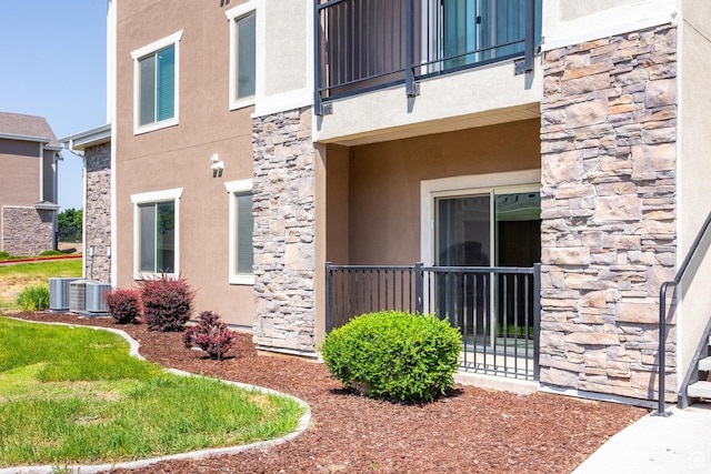 136 W Spring Hill Way Unit 801, Saratoga Springs, UT 84045 - view of side of property featuring stone siding, stucco siding, and a balcony