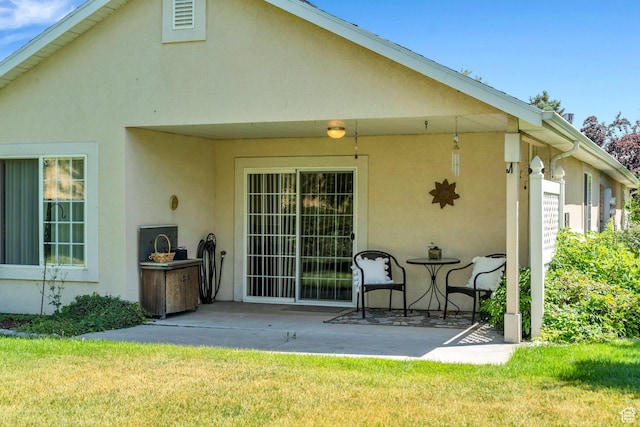 1408 W Westbridge Dr S, Provo, UT 84601 - back of property featuring stucco siding, a patio, and a lawn