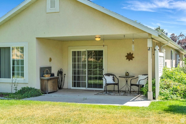 1408 W Westbridge Dr S, Provo, UT 84601 - back of house featuring stucco siding, a patio, and a yard