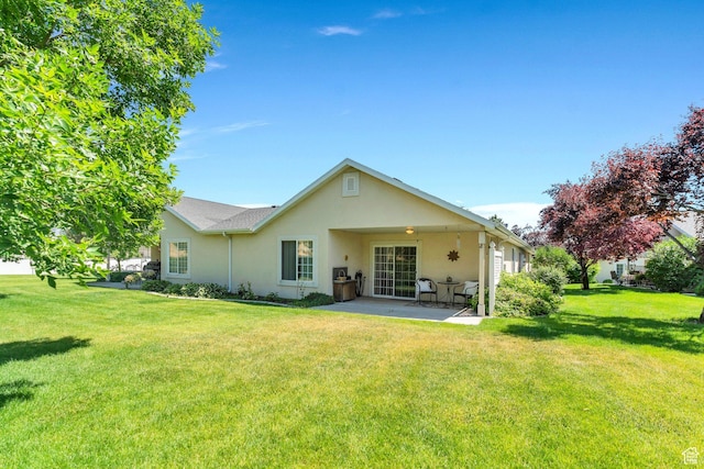 1408 W Westbridge Dr S, Provo, UT 84601 - rear view of house featuring stucco siding, a patio, and a yard