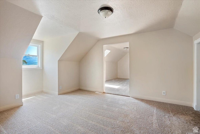 409 N 9000 E, Huntsville, UT 84317 - bonus room with vaulted ceiling, a textured ceiling, and light colored carpet