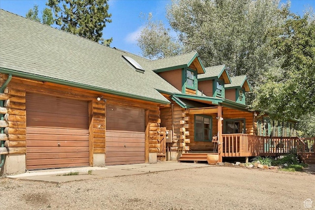 409 N 9000 E, Huntsville, UT 84317 - log home featuring log siding, a garage, driveway, and a shingled roof