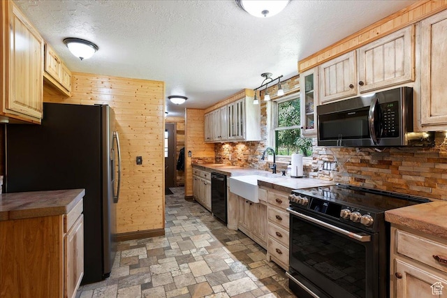 409 N 9000 E, Huntsville, UT 84317 - kitchen featuring black appliances, backsplash, glass insert cabinets, a textured ceiling, and light stone finish flooring