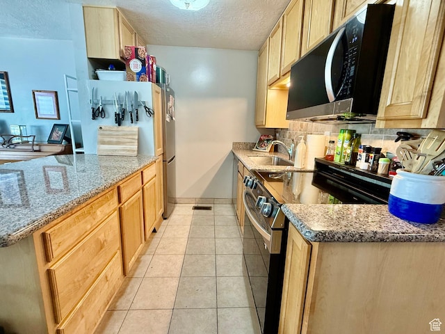 3677 S 2200 W Unit 41, West Valley City, UT 84119 - kitchen featuring stainless steel appliances, a textured ceiling, light brown cabinetry, light tile patterned floors, and decorative backsplash