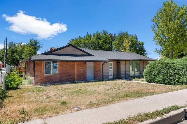 2317 N Timpview Dr E, Provo, UT 84604 - view of front facade featuring brick siding, roof with shingles, a front yard, and a chimney