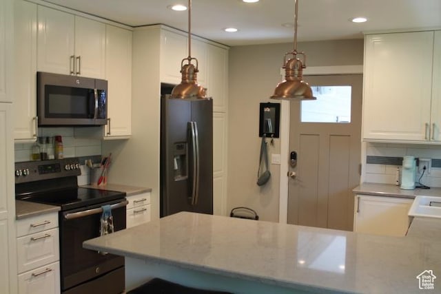 1268 E Edenbrook Dr, Sandy, UT 84094 - kitchen featuring stainless steel microwave, electric range, fridge with ice dispenser, backsplash, and recessed lighting