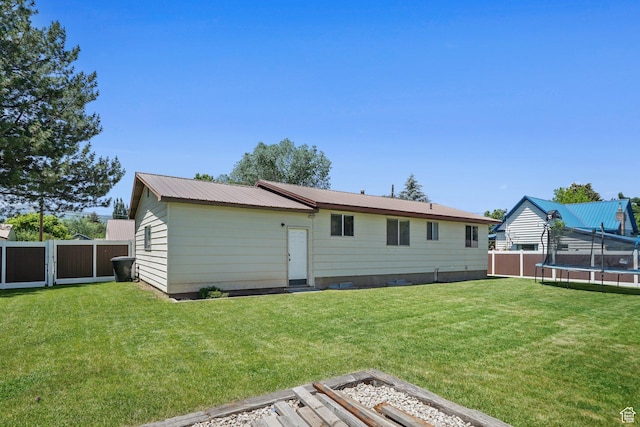 451 S 200 E, Heber City, UT 84032 - back of property with a trampoline, a fenced backyard, and a metal roof