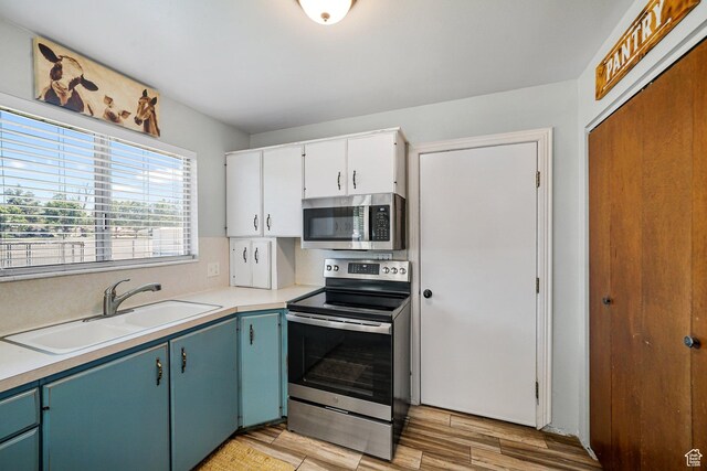 451 S 200 E, Heber City, UT 84032 - kitchen with stainless steel appliances, light wood-style floors, light countertops, and white cabinets