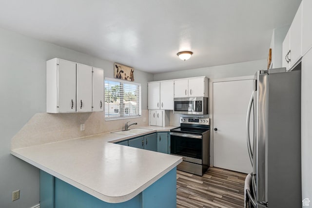 451 S 200 E, Heber City, UT 84032 - kitchen featuring appliances with stainless steel finishes, a peninsula, dark wood finished floors, light countertops, and white cabinets