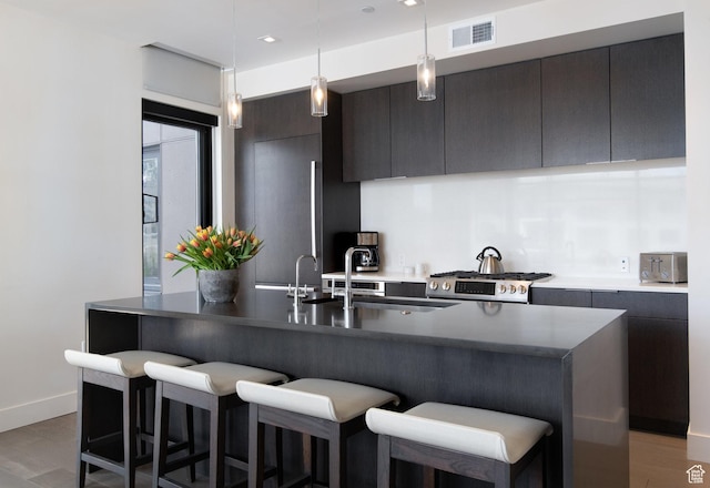 2431 W High Mountain Rd Unit 504, Park City, UT 84098 - kitchen with a kitchen bar, hanging light fixtures, an island with sink, recessed lighting, and modern cabinets