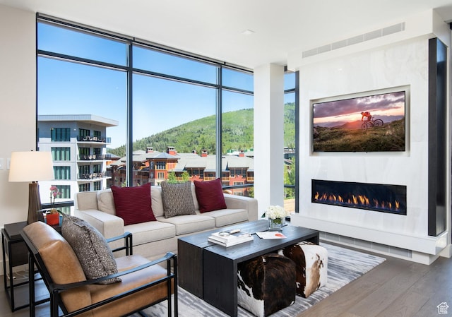 2431 W High Mountain Rd Unit 504, Park City, UT 84098 - living area with a wall of windows, wood finished floors, and a glass covered fireplace