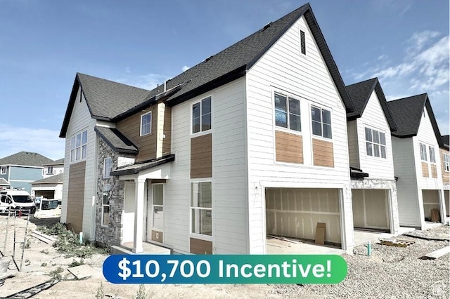 2719 N 2775 W Unit 120, Plain City, UT 84404 - view of front facade with a garage and a shingled roof