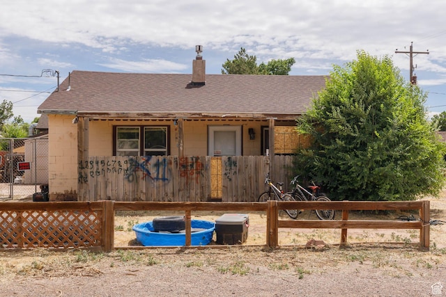 199 S 200 E, Richfield, UT 84701 - view of front of house with roof with shingles, concrete block siding, and a chimney