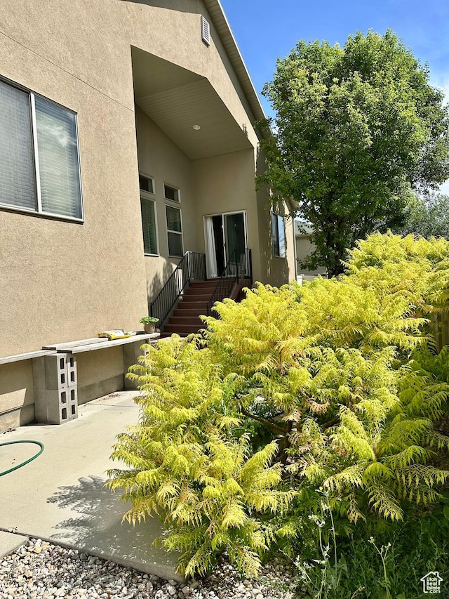 12413 S Andreas St W, Riverton, UT 84065 - view of exterior entry featuring stucco siding and a patio