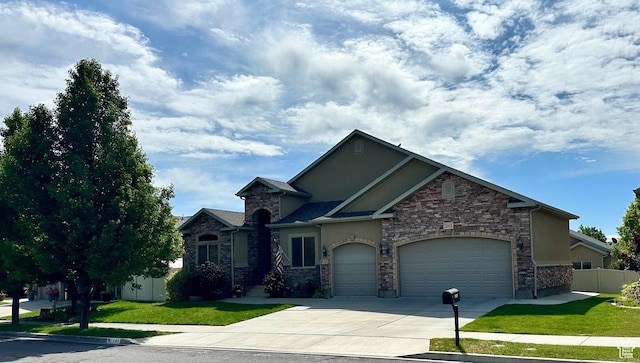 12413 S Andreas St W, Riverton, UT 84065 - view of front facade featuring stucco siding, concrete driveway, an attached garage, and stone siding
