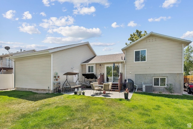 3573 S Deann Dr W, West Valley City, UT 84128 - back of property with a patio and a lawn